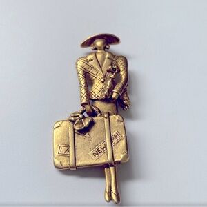 Unique Gold-tone lady with suitcase Brooch with Intricate Design. New York.